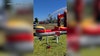 Firefighters make kids' day by hosing down bouncy slide