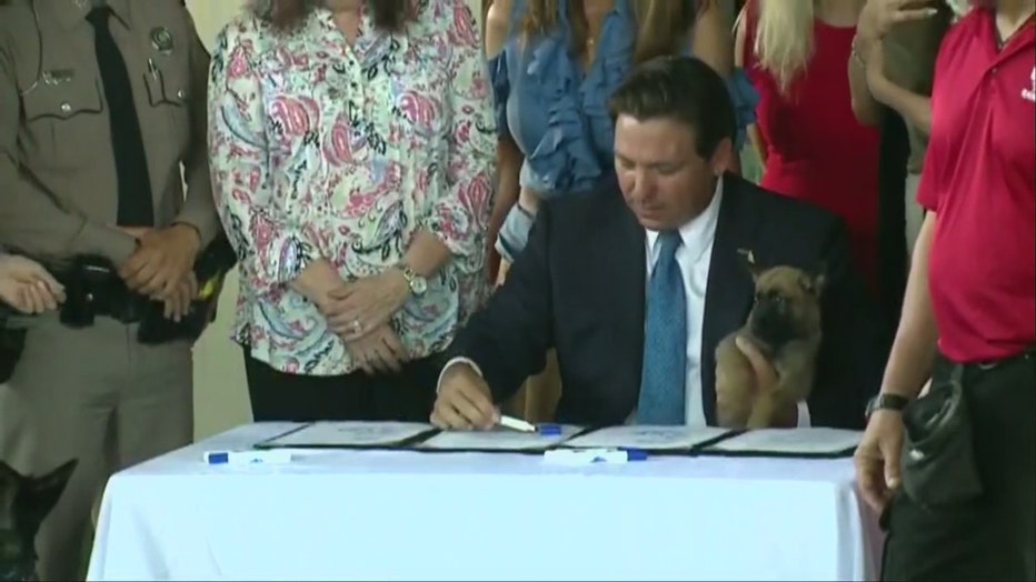 Pictured: Gov. Ron DeSantis signs Dexter's Law and Trooper's Law in Loxahatchee on May 28, 2025.