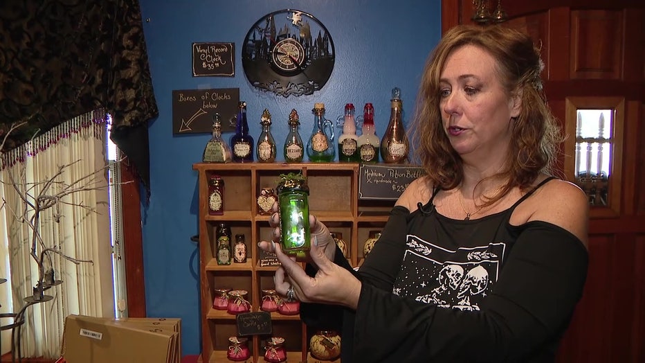 Mad Dragon Studio owner Sarah Hamilton shows off one of her potions.