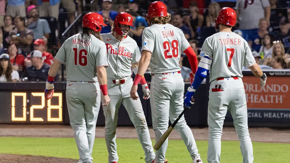 TAMPA, FL - MAY 08: Bryson Stott #5 of the Philadelphia Phillies celebrates with Brandon Marsh #16, Alec Bohm #28, Trea Turner #7 after hitting a three-run home run in the eighth inning during the game between the Philadelphia Phillies and the Tampa Bay Rays at George M. Steinbrenner Field on Thursday, May 8, 2025 in Tampa, Florida. (Photo by Carlee Calfee/MLB Photos via Getty Images)