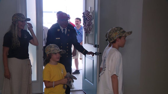 Two families get mortgage-free houses in Tunnels to Towers village