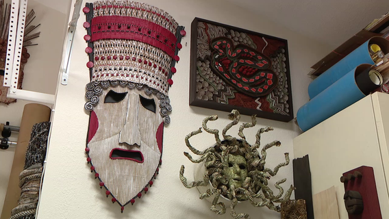 Woman creates art from old cardboard material