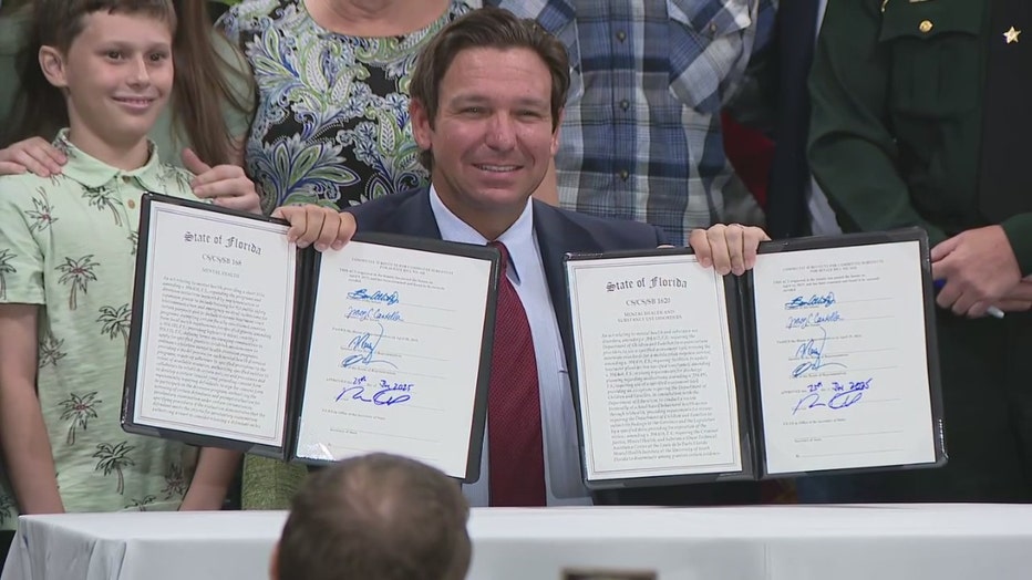 Pictured: Gov. Ron DeSantis signs bills at a news conference in Tampa on June 25, 2025.