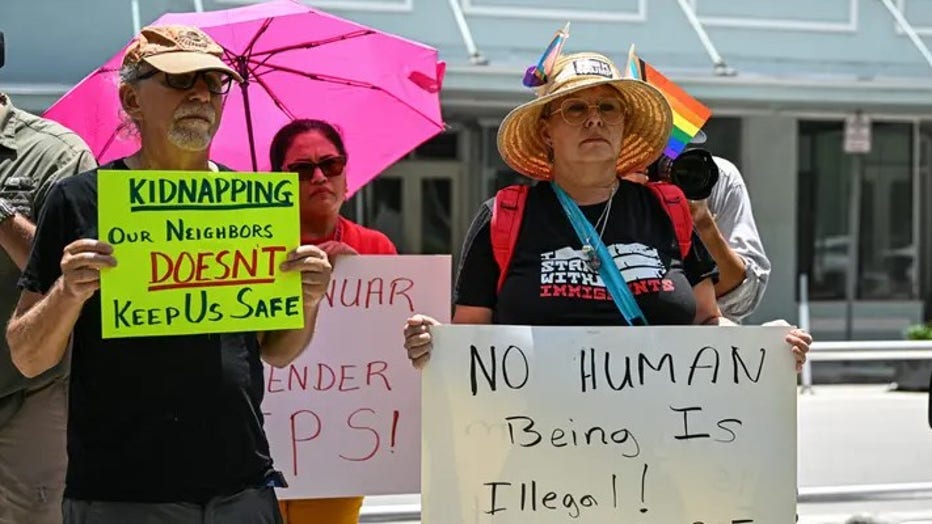 Demonstrators rally outside Miami Federal Court calling for Governor Ron DeSantis to abide by the court's restraining order blocking enforcement of a new immigration law, in Miami on May 29, 2025. Federal Judge Kathleen Williams issued a temporary injunction against the immigrant law, which according to opponents, created new state crimes targeting immigrants entering and living in Florida. (Photo by CHANDAN KHANNA / AFP) (Photo by CHANDAN KHANNA/AFP via Getty Images) (Getty Images/Chandan Khanna)