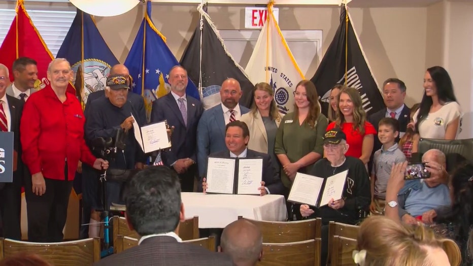 Pictured: Gov. Ron DeSantis signs bills into law in Port Charlotte on June 6, 2025.