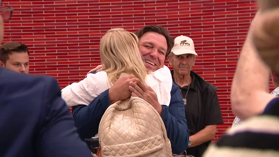 Pictured: Gov. Ron DeSantis greets passengers getting off a rescue flight from Israel at Tampa International Airport on June 20, 2025.