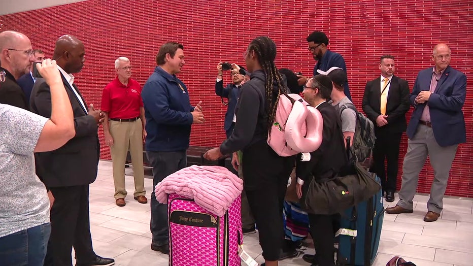 Pictured: Gov. Ron DeSantis greets passengers getting off a rescue flight from Israel at Tampa International Airport on June 20, 2025.
