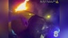 VIDEO: Officers smash through glass to rescue woman trapped in burning car