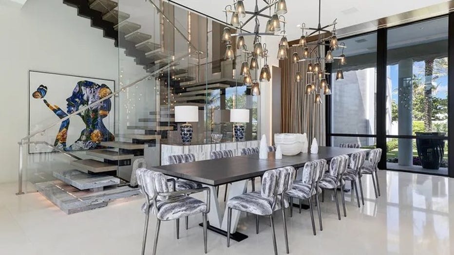 The dining table is placed in front of a staircase leading upstairs. (Legendary Productions / Luxury Resort Portfolio)