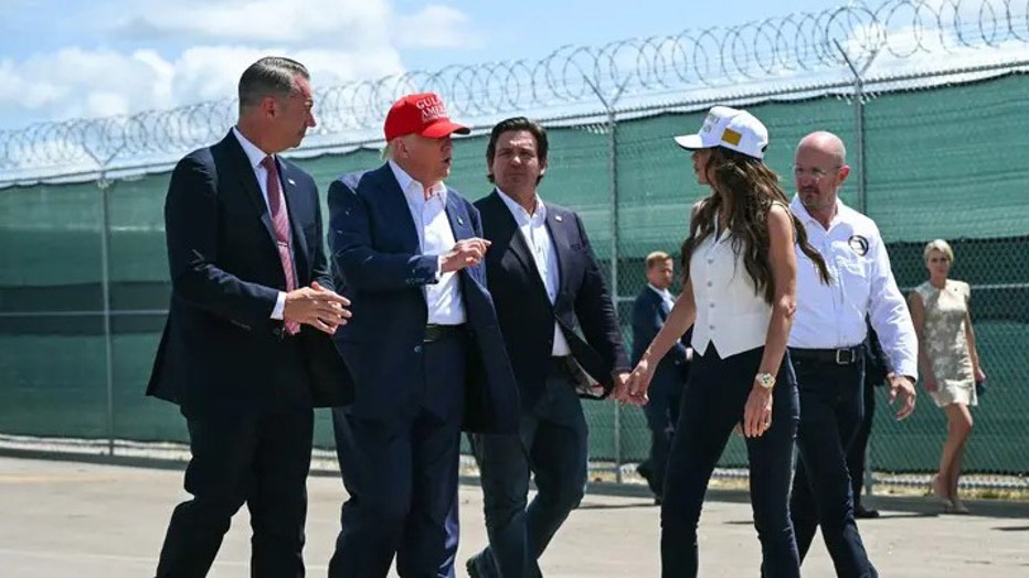 US President President Donald Trump, Florida Governor Ron DeSantis, and DHS Secretary Kristi Noem tour a migrant detention center, dubbed "Alligator Alcatraz," located at the site of the Dade-Collier Training and Transition Airport in Ochopee, Florida on July 1, 2025. (Andrew Caballero-Reynolds/AFP via Getty)