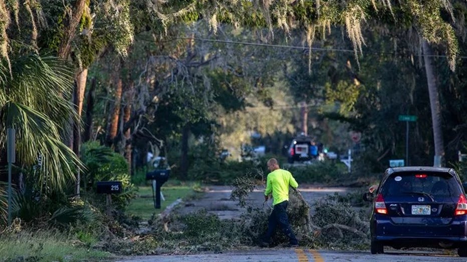 A worker clears downed limbs in Perry, FL, after Hurricane Helene passed through on Friday, September 27, 2024. (Ted Richardson/For The Washington Post / Getty Images)
