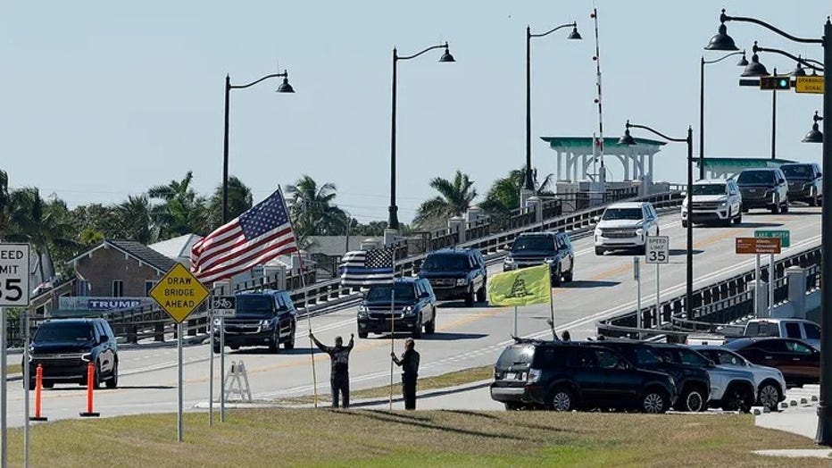 Supporters wave at President-elect Donald Trump's motorcade as it passes along Southern Boulevard while returning to Trump's Mar-a-lago Club on Dec. 03, 2024, in Palm Beach, Florida. (Chip Somodevilla/Getty Images)