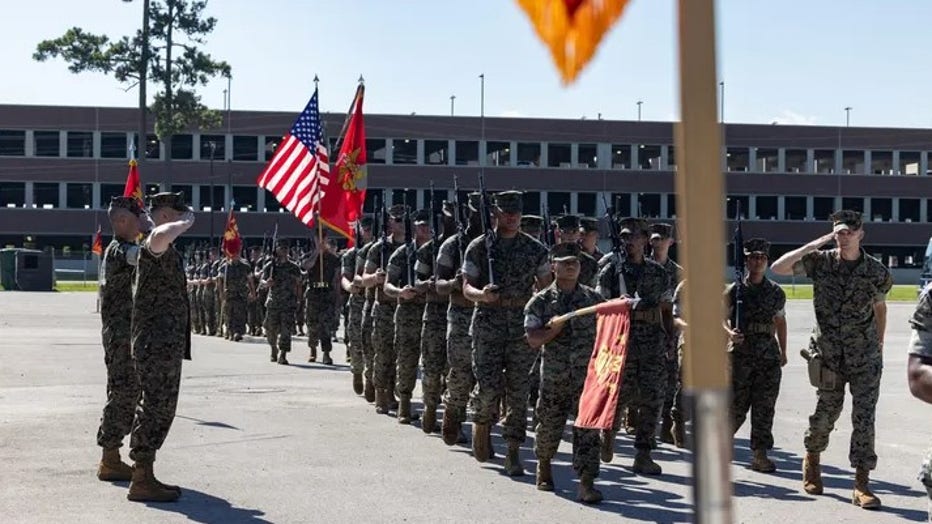 U.S. Marine Corps Lt. Col. Brandon Mokris, left, from North Carolina, the outgoing commanding officer of Marine Wing Support Squadron (MWSS) 272, and Lt. Col. Sean O’Rourke, from Minnesota, the oncoming commanding officer of MWSS-272, observe the pass and review during a change of command ceremony at Marine Corps Air Station New River, North Carolina, June 18, 2025. (U.S. Marine Corps photo by Cpl. Loriann Dauscher)