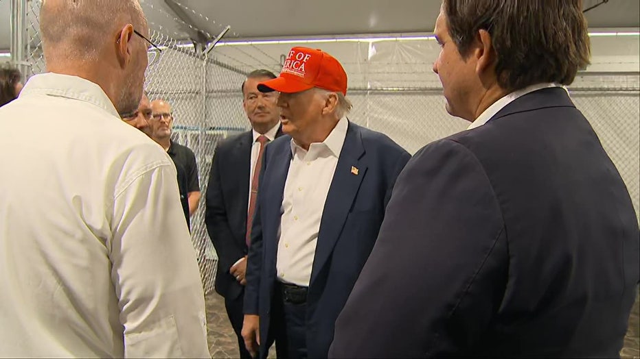 Pictured: President Donald Trump, Florida Gov. Ron DeSantis and other officials tour the "Alligator Alcatraz" immigration detention facility in the Florida Everglades on July 1, 2025.