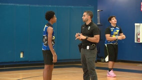 Tampa police officers build bonds with youth in summer basketball league