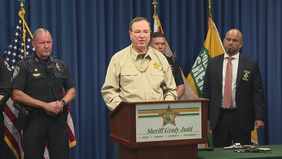 Sheriff Grady Judd dons $50K in ‘drip’ seized during illegal drug trafficking bust that nabbed 32