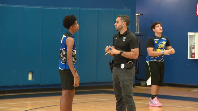 Tampa police officers build bonds with youth in summer basketball league