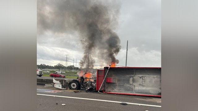 Tractor-trailer bursts into flames after slamming into median