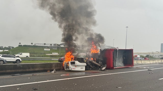 Tractor-trailer bursts into flames after slamming into median