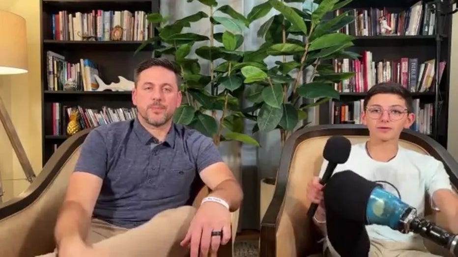 Jameson Reeder Sr. and Jameson Jr. showing the image of a shark on his prosthetic leg. (Fox News Digital)