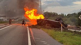 Tractor-trailer bursts into flames from fuel leak after overturning: FHP