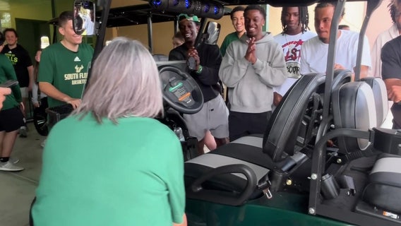 USF men's basketball team gives back to long-time team administrative specialist