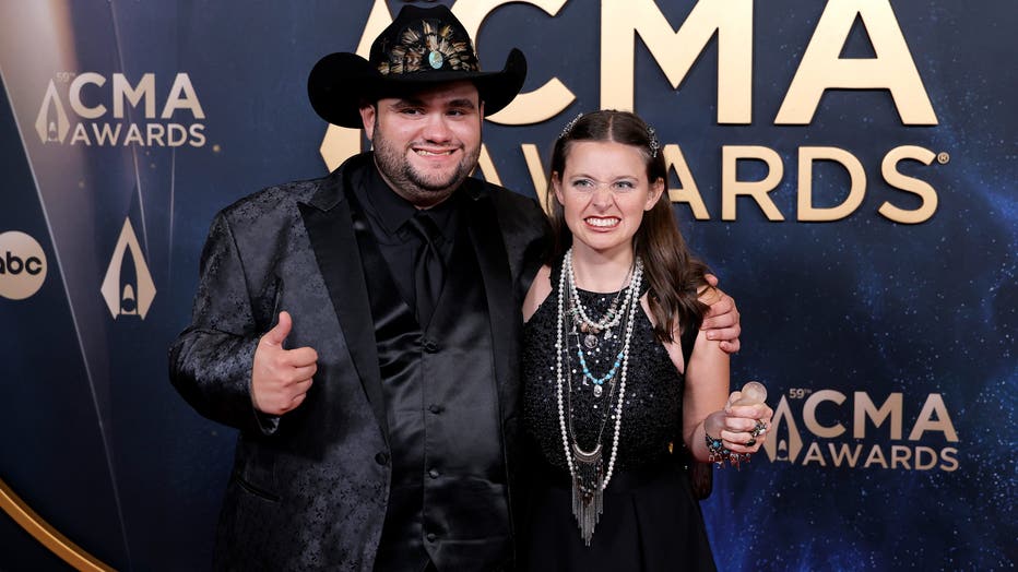 NASHVILLE, TENNESSEE - NOVEMBER 19: EDITORIAL USE ONLY (L-R) Tyler White and Madison Marilla attend the 59th Annual CMA Awards at Music City Center on November 19, 2025 in Nashville, Tennessee. (Photo by Tibrina Hobson/FilmMagic)