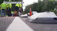 Crews place protective dividers along St. Petersburg bike lanes