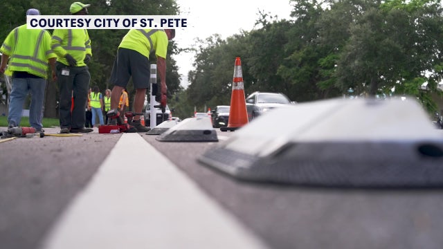 Crews place protective dividers along St. Petersburg bike lanes