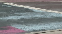 Covered St. Pete Pride mural peaks through black paint on Central Avenue