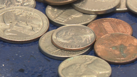 Loose change left at airport checkpoints may be used to build wall