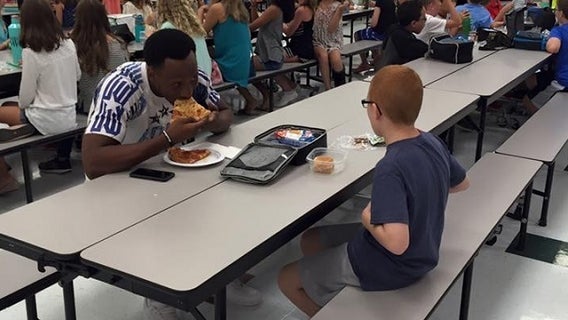 College football player eats lunch with boy with autism who was sitting alone