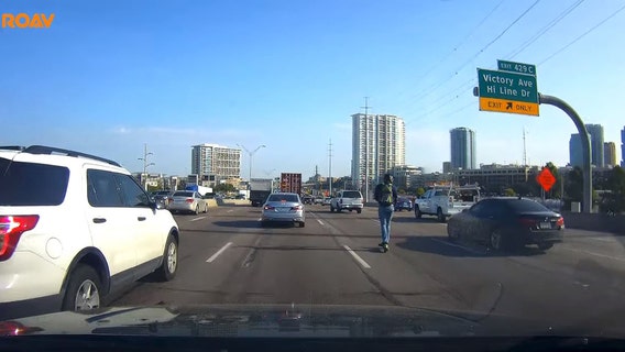 Dash camera captures Lime scooter rider on I-35 in downtown Dallas during rush hour