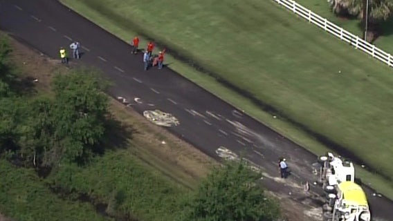 Overturned concrete truck collapses road