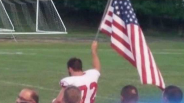 Football player raises American flag when he sees school doesn't have one