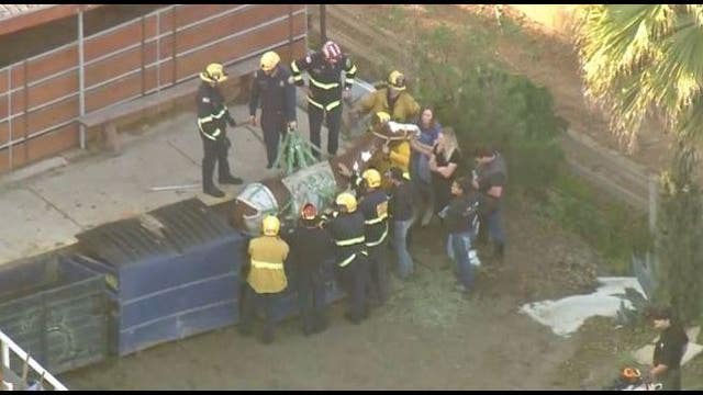 Fire crews rescuing a horse stuck in dumpster in Huntington Beach