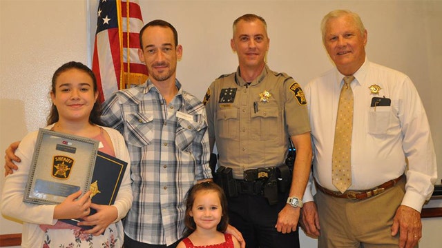 12-year-old honored for her life-saving actions after dad passes out behind wheel