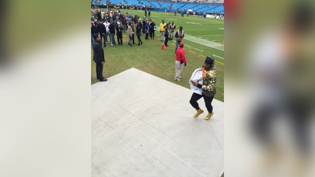 Cam Newton tears down Packers banner in Bank of America stadium