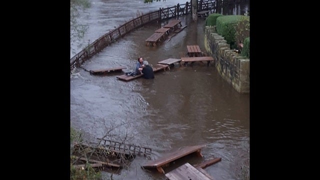 Beer garden patrons enjoy pints in waist deep water