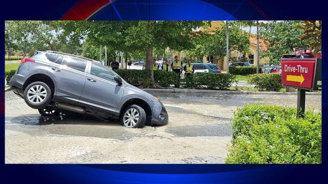 Sinkhole partially swallows car outside Florida McDonald's