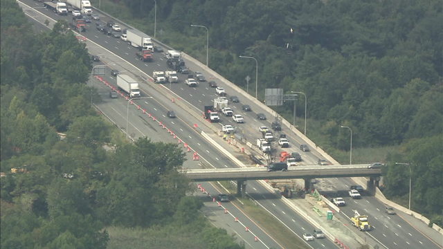 One lane open but heavy traffic, 10 hours after truck flipped, spilled pennies