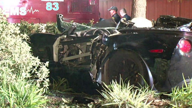 Firefighters remove male from crashed Corvette
