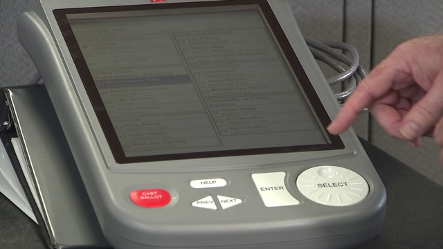 Harris County Clerk demonstrates how to use poll machines