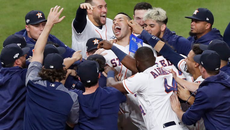 HOUSTON, TX: The Houston Astros celebrate with Carlos Correa #1 after his walk-off solo home run in the 11th inning in game two of the American League Championship Series against the New York Yankees at Minute Maid Park on October 13, 2019 in Houston, Texas.