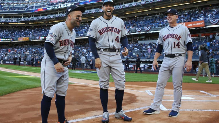 BRONX, NY - OCTOBER 15: Jose Altuve #27 and George Springer #4 of the Houston Astros joke with manager AJ Hinch #14 during player announcements prior to Game 3 of the ALCS between the Houston Astros and the New York Yankees at Yankee Stadium on Tuesday, October 15, 2019 in the Bronx borough of New York City. 