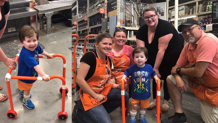 38d4b61e-Logan and his walker with Home Depot employees_1559061855794.jpg.jpg