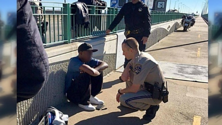 f1d50736-officer talks man from jumping_1479465781209-404959.jpg