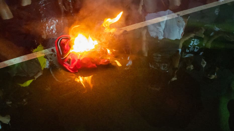 HONG KONG, CHINA: Lebron James jersey burns during a rally at the Southern Playground in support of NBA's Houston Rockets' team general manager Daryl Morey, who sent a tweet backing the pro-democracy movement on October 15, 2019 in Hong Kong, China. Anti-government demonstrations in Hong Kong stretched into its fifth month after the Chinese territory's government invoked emergency powers earlier this month to introduce an anti-mask law. Protesters continue to call for Hong Kong's Chief Executive Carrie Lam to meet their remaining demands since the controversial extradition bill was withdrawn, which includes an independent inquiry into police brutality, the retraction of the word 