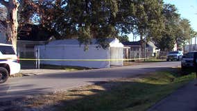 Officers set up crime scene tape, tent at Harding Street raid home