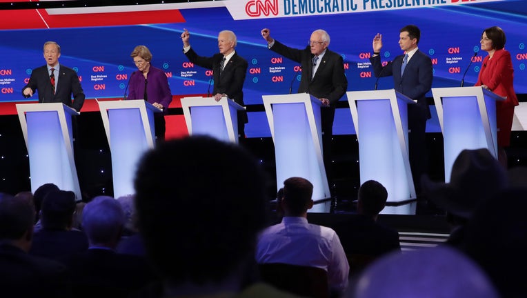 Tom Steyer (L) speaks as (L-R) Sen. Elizabeth Warren (D-MA), former Vice President Joe Biden, Sen. Bernie Sanders (I-VT) and former South Bend, Indiana Mayor Pete Buttigieg (R) react during the Democratic presidential primary debate at Drake University in Des Moines, Iowa.